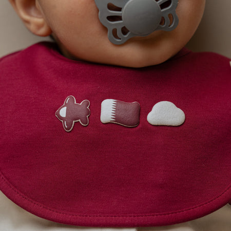 Baby wearing Qatar baby bib