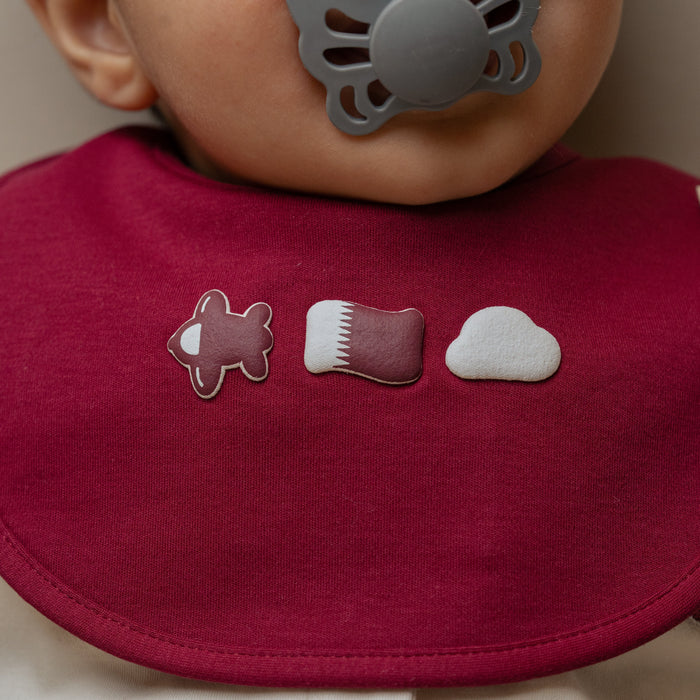 Baby wearing Qatar baby bib