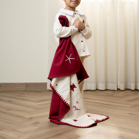 Child wearing a toddler suit with a custom baby blanket