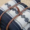 Sadu patterned cushions set with leather strap on a desert surface