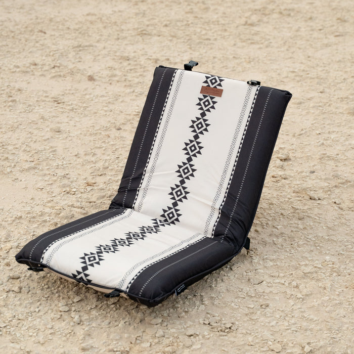Sadu Patterned chair cushion on a sandy surface