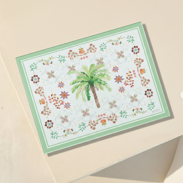Multi functional serving board with a palm tree and floral patterns on a beige background