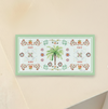 Multi functional serving board with palm tree and flowers on a beige background